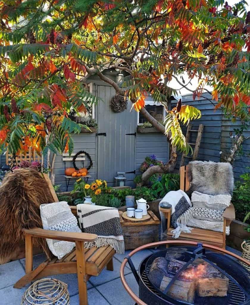 wood chairs around fire pit small patio