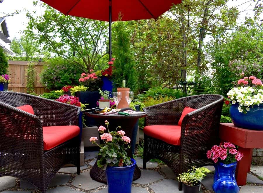 wicker armchairs small patio with flowers
