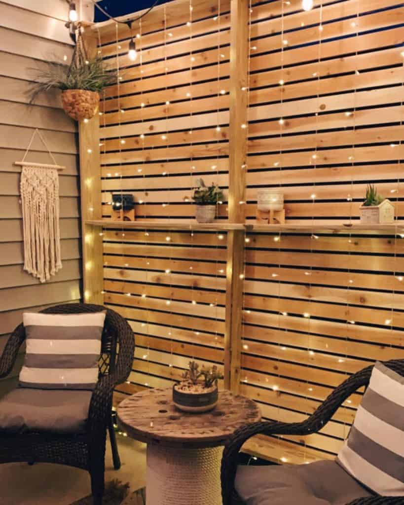 wood privacy wall patio with string lights