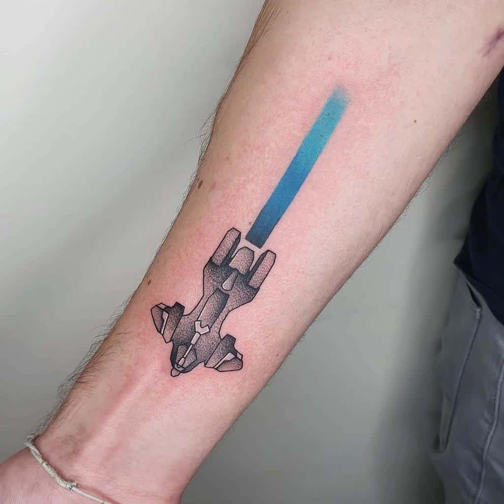 Minimalist Halo tattoo of a Pelican dropship with a blue energy trail, blending sci-fi and sleek design, inked on the forearm.