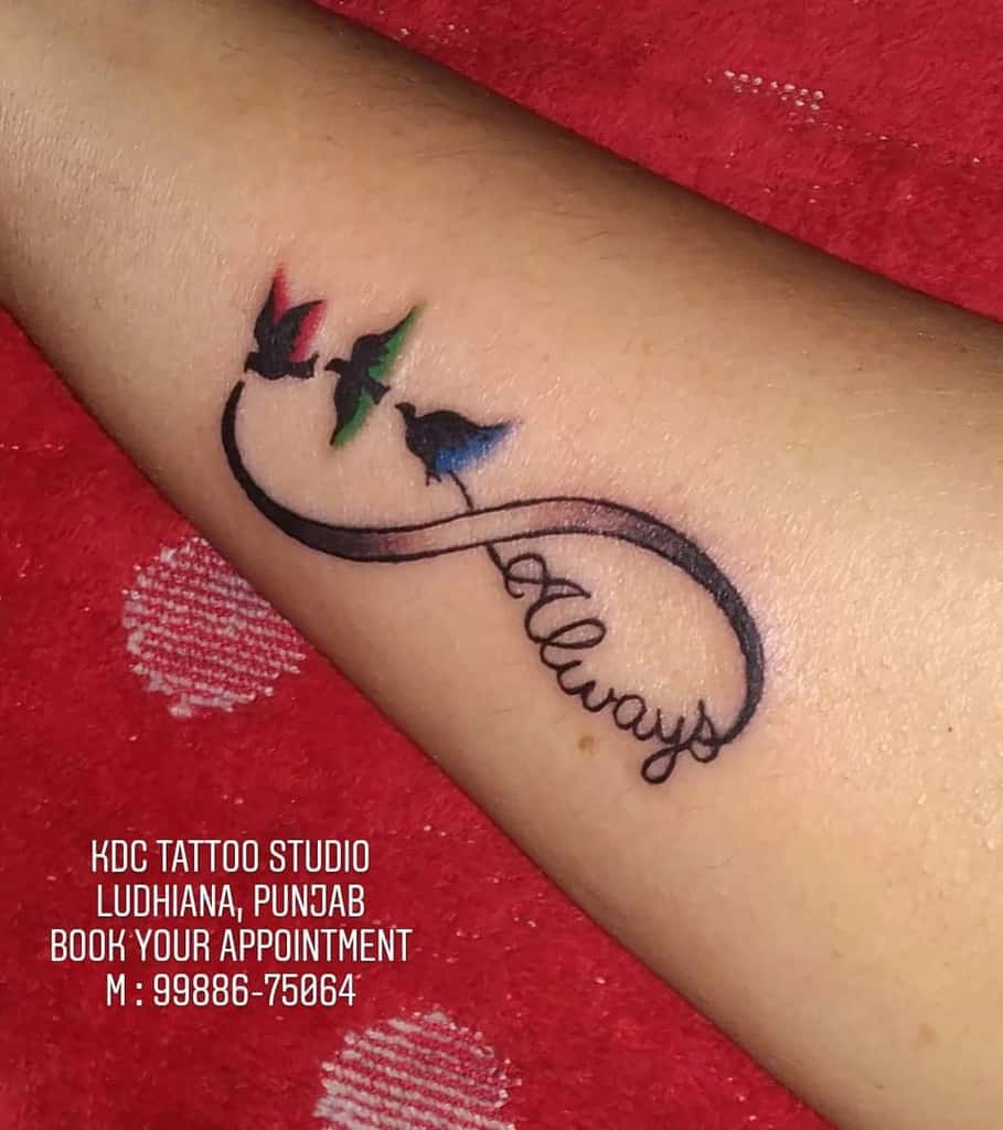Colorful infinity tattoo with flying birds and 'Always' in cursive, symbolizing eternal freedom and love