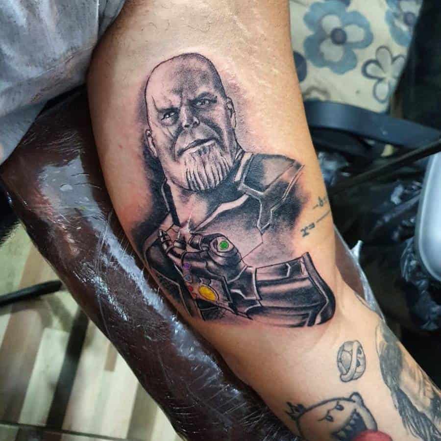 Realistic black and grey Thanos tattoo with glowing Infinity Stones