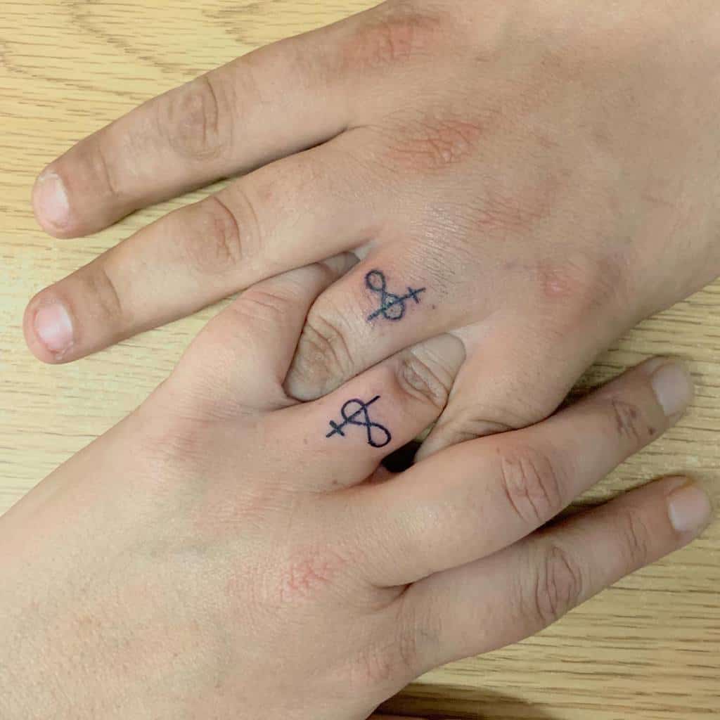 Matching wedding ring tattoos featuring intertwined symbols, with both symbol featuring a combination of plus signs and infinity