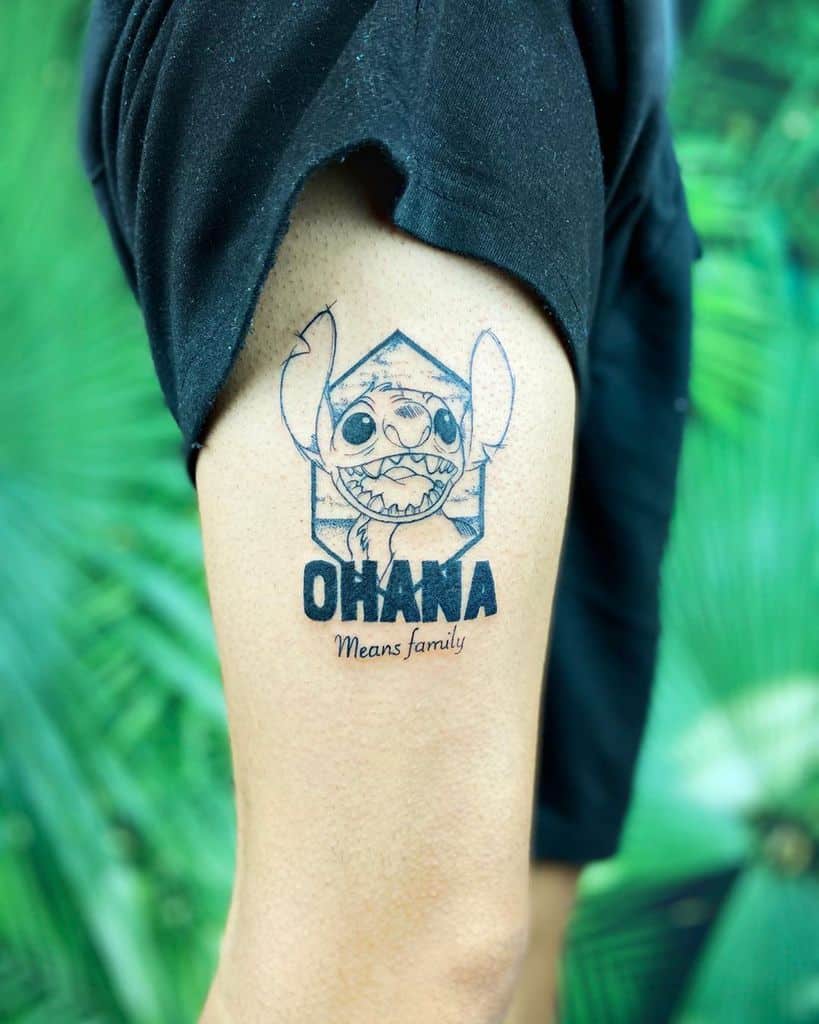 Black and white tattoo of Stitch from Lilo & Stitch inside a hexagonal frame, with the word 'OHANA' above and 'Means family' below, on the upper arm.