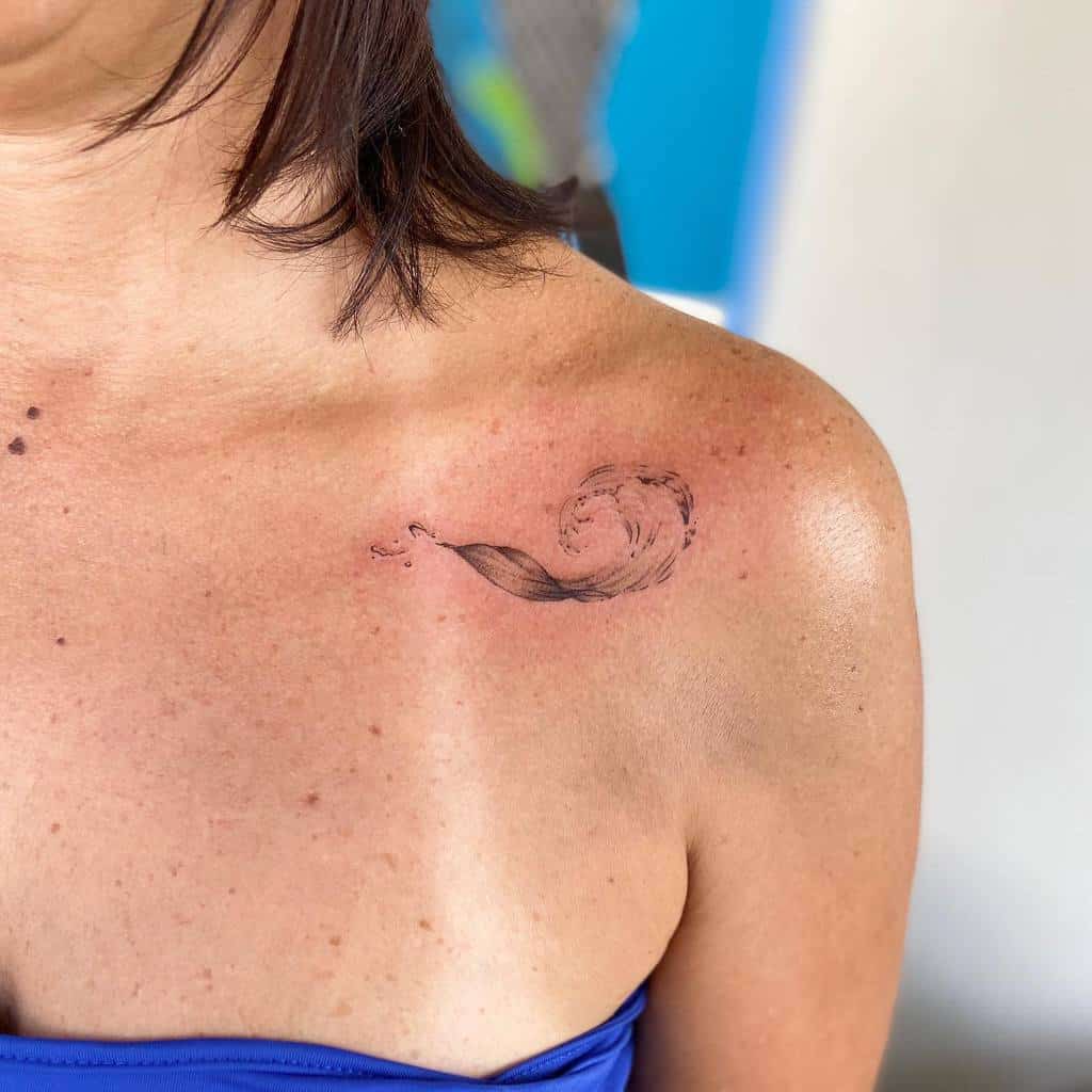 Minimalist ocean wave tattoo, featuring delicate fine lines and soft shading for a natural, flowing design