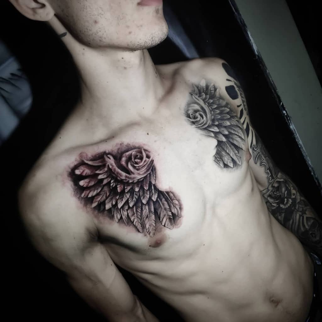 A black and grey tattoo featuring a rose merging into angel wings