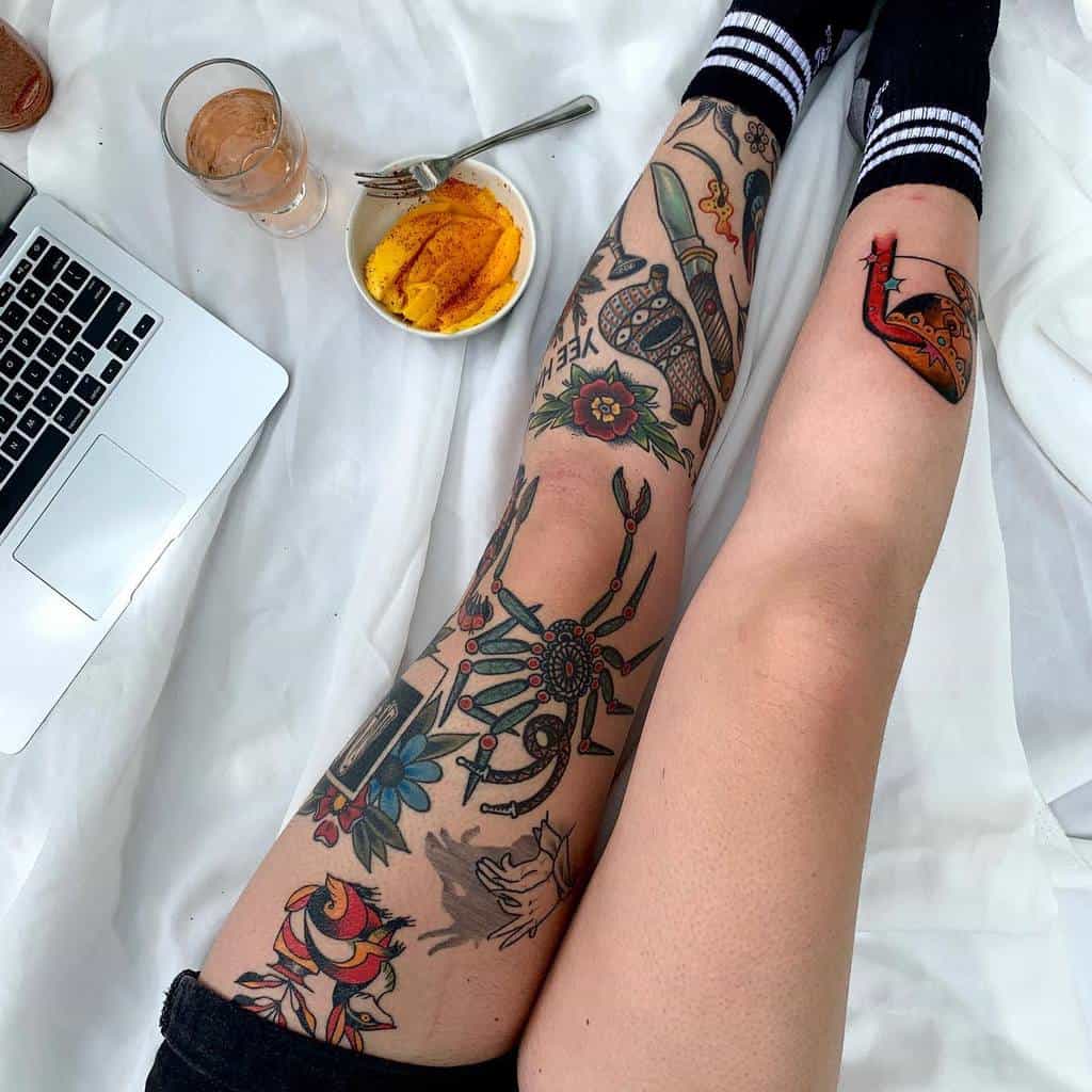 Colorful tattoo leg sleeve, featuring a mix of traditional designs including a spider, flowers, a knife, cup with flowing wine with stars and a hand