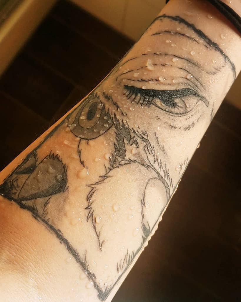 Black and grey forearm tattoo of Moro, the wolf goddess, with intense eyes and fur details, inspired by Princess Mononoke.