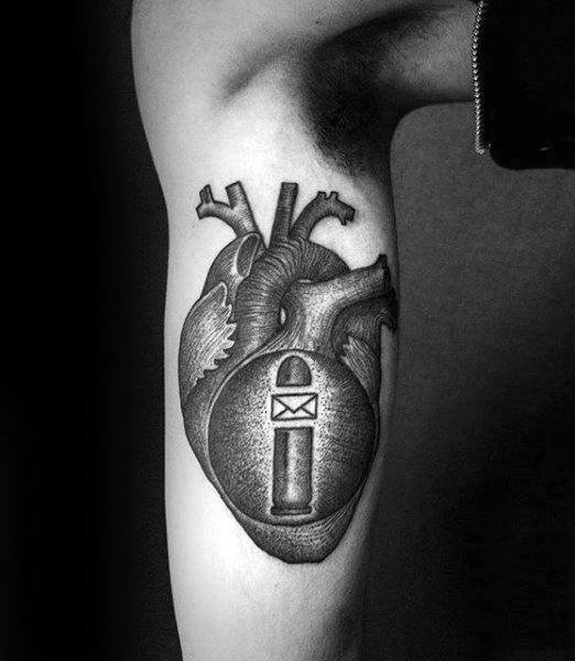 Arm tattoo of an anatomical heart with a bullet and envelope design in black and white