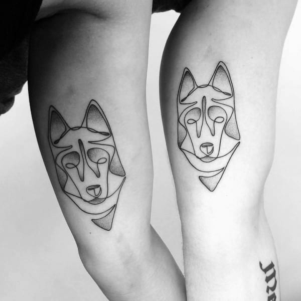 Minimalist Siberian Husky tattoos on two arms, featuring a continuous line design with geometric elements for a modern and artistic look.