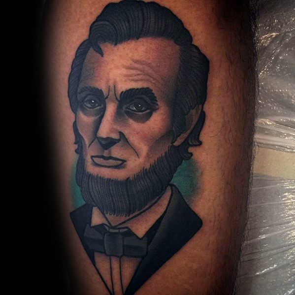 Tattoo of Abraham Lincoln's portrait with a beard and formal attire on a person's skin