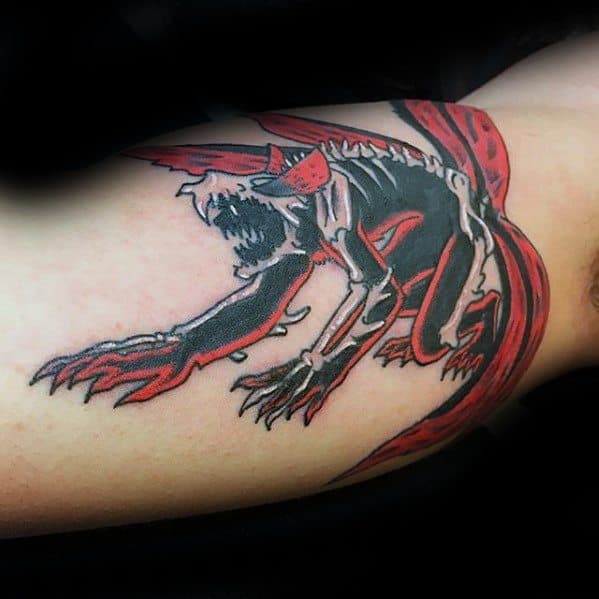 Tattoo of a fierce, skeletal beast with red accents and sharp claws, resembling a creature from Naruto