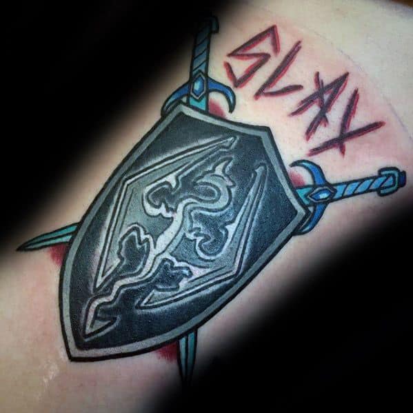 Tattoo of a Skyrim shield with swords and "SLAY" in bold red letters above