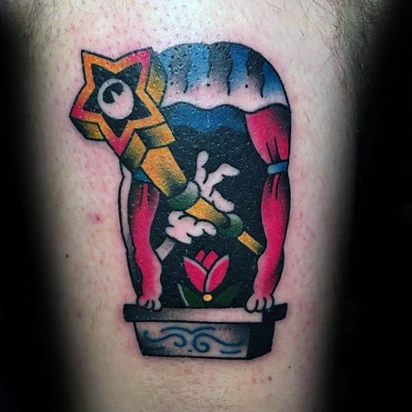 Vibrant tattoo of a telescope with a star-shaped eyepiece, pointing out a window framed by red curtains, overlooking a tulip in a flower box