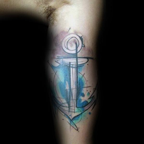 Abstract anchor tattoo with blue and black watercolor effects on a bicep