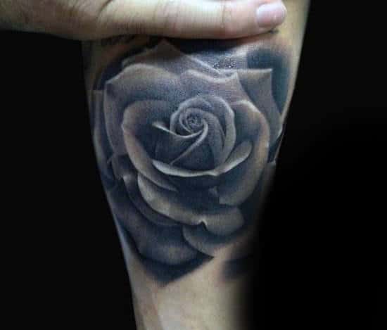 Black and gray rose tattoo on forearm