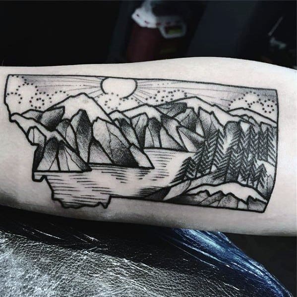 Montana-shaped tattoo with stylized mountains, lake, sun, and pine forest, combining bold lines with dotwork detailing.
