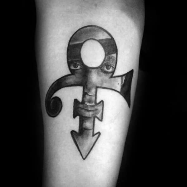 A striking tattoo of Prince's iconic Love Symbol with his face subtly integrated into the design