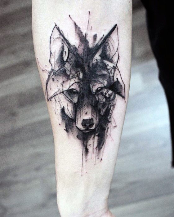 Black ink wolf tattoo on forearm with sketch-style lines, abstract shading, and geometric elements for a bold, modern design.