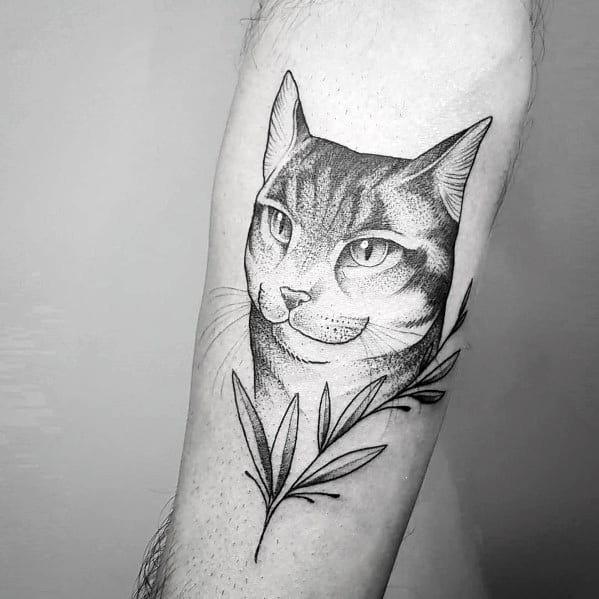 Fine-line cat tattoo with delicate shading and botanical elements, creating an elegant and minimalist design on the forearm.