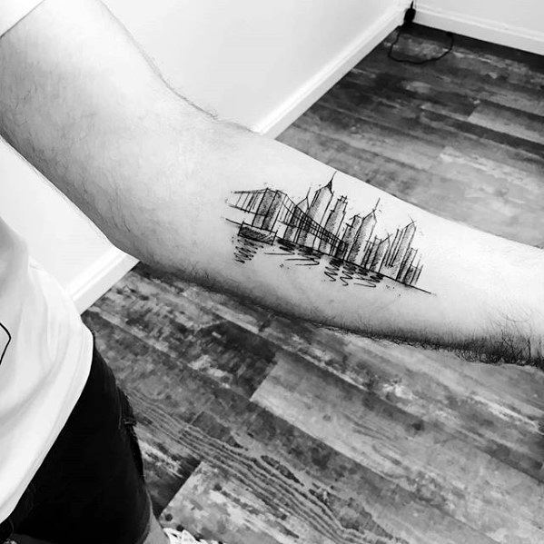 Minimalist inner forearm tattoo of the New York City skyline with bridge and water reflection in fine black linework.