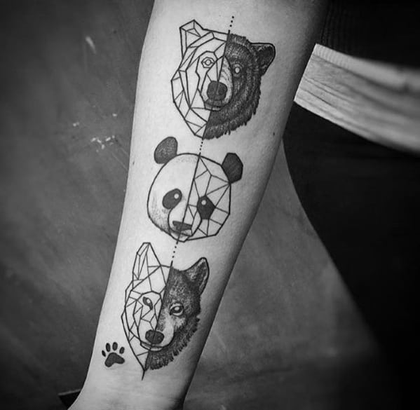Geometric forearm tattoo with half-realistic, half-line art bear, panda, and wolf faces aligned vertically with a small paw print.