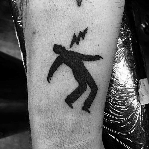 Solid black tattoo of a figure being struck by a lightning bolt, inspired by the warning sign from Green Day’s *Warning* album era.