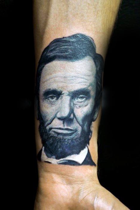 Black and gray forearm tattoo of Abraham Lincoln with a beard