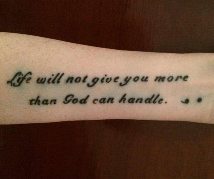 The tattoo features the empowering phrase, "Life will not give you more than God can handle," with semicolons at the end, symbolizing strength, faith, and resilience.