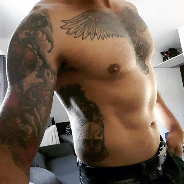 Full-body tattoo design featuring a detailed eagle on the chest, a skull on the ribs, and colorful sleeve tattoos on the arm