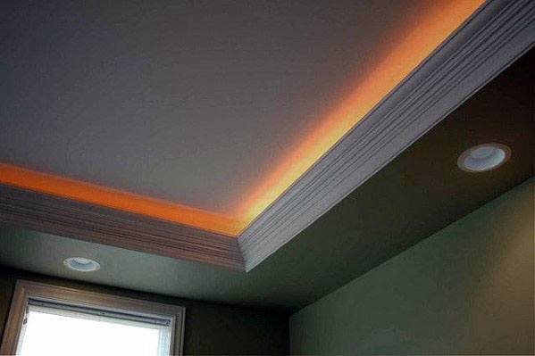 Cozy room with warm orange LED crown molding lighting, enhancing the atmosphere with soft glow