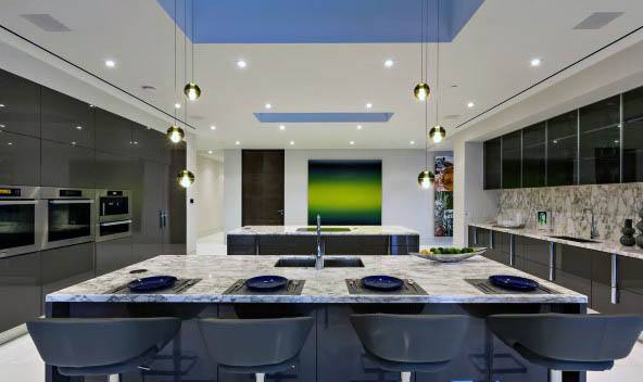 Modern kitchen with marble backsplash, integrated sink, and dark wood cabinetry.