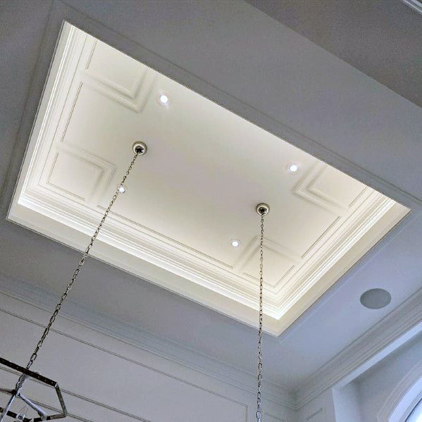 Elegant ceiling design with crown molding lighting and recessed spotlights, adding sophistication to the room