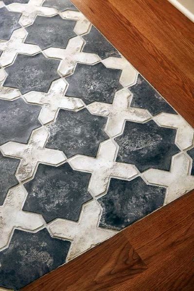 patterned marble entryway tiles with wooden border