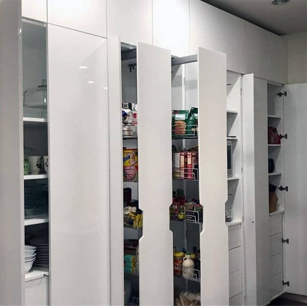 Glossy white pantry with pull-out storage and sleek modern design.