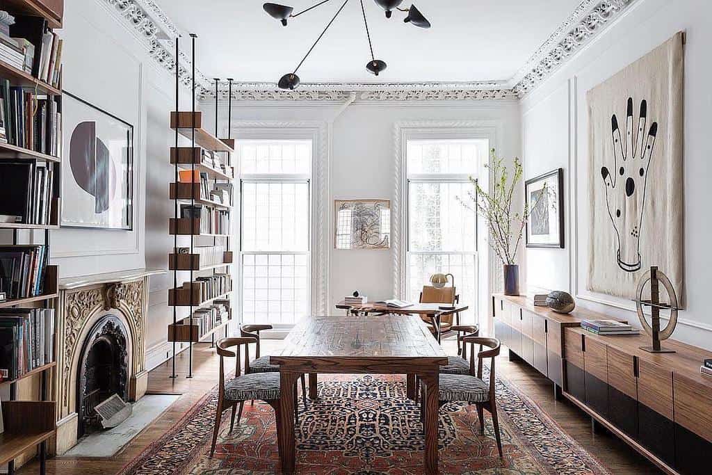 vintage dining room wood table fireplace bookshelf sputnik chandelier