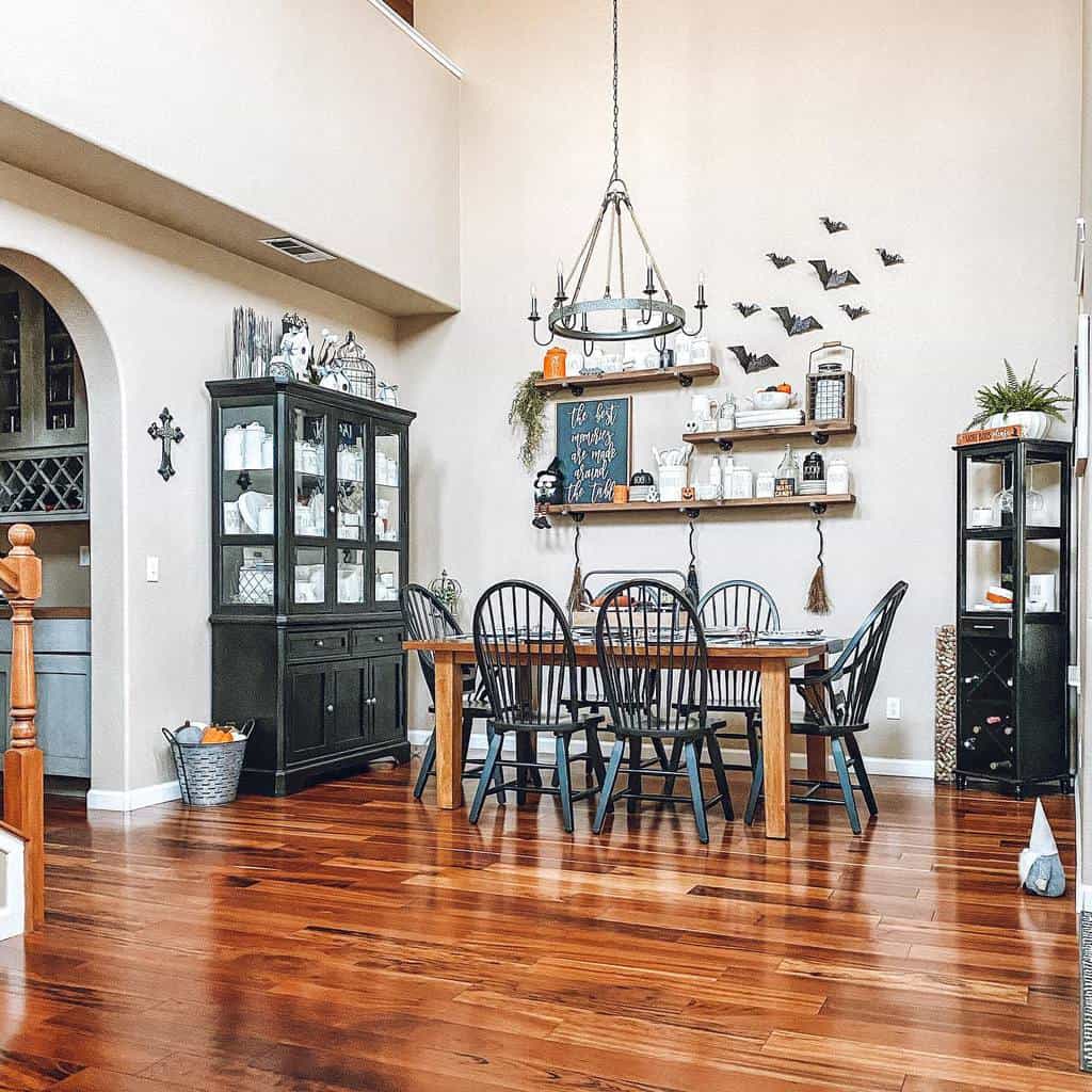 vintage dining room table black chairs and cabinets wood floor bats on wall hanging shelves