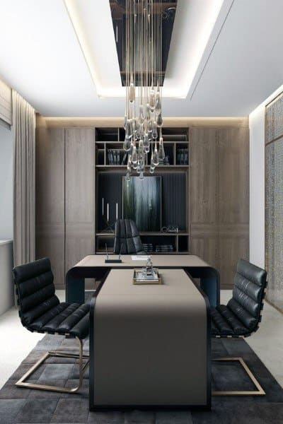 Luxurious home office with sleek desk, leather chairs, and modern chandelier.
