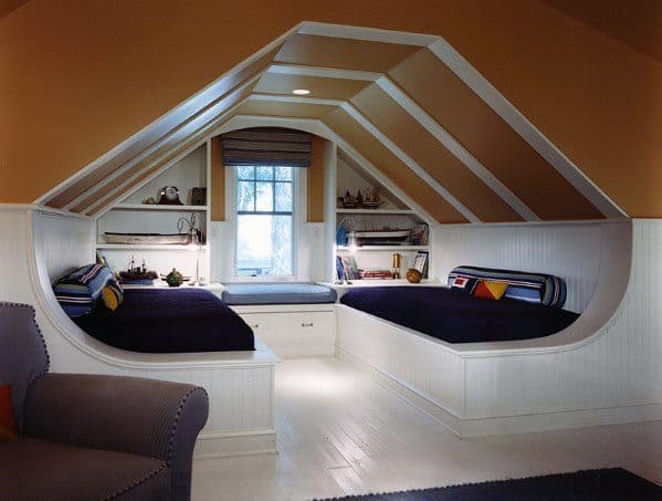 ozy attic nook featuring built-in twin beds, shelving, and a window seat.