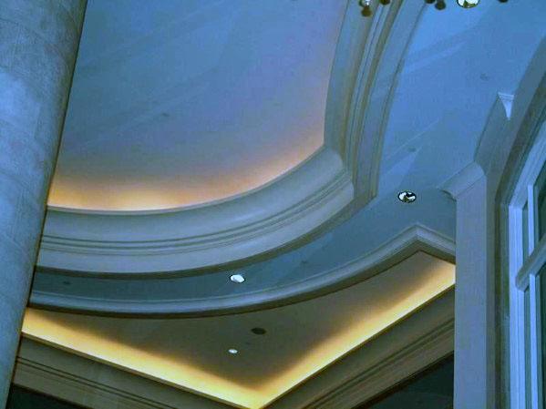 Elegant interior with curved crown molding lighting, soft ambient light enhancing the sophisticated design