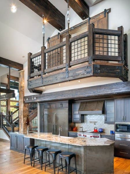 Rustic loft kitchen with wood beams, industrial accents, and an elevated balcony.