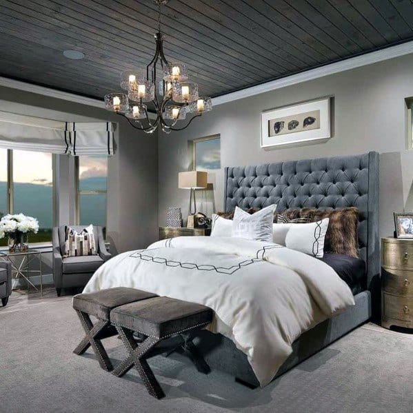 rustic style master bedroom with wood panel ceiling and chandelier