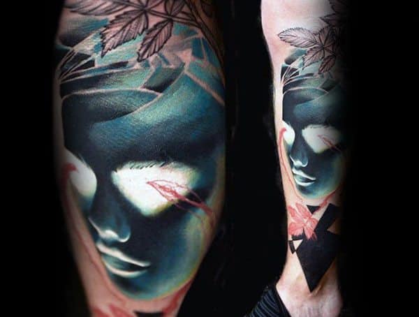Surrealist tattoo featuring a glowing abstract face with bold shading, soft highlights, and artistic leaf details for a dreamlike effect.