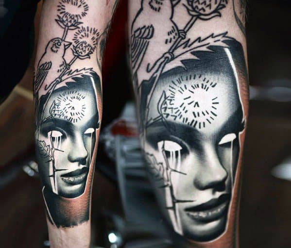 Inverted tattoo of a stylized female face with hollow eyes, mechanical elements, and clockwork patterns for a futuristic look.