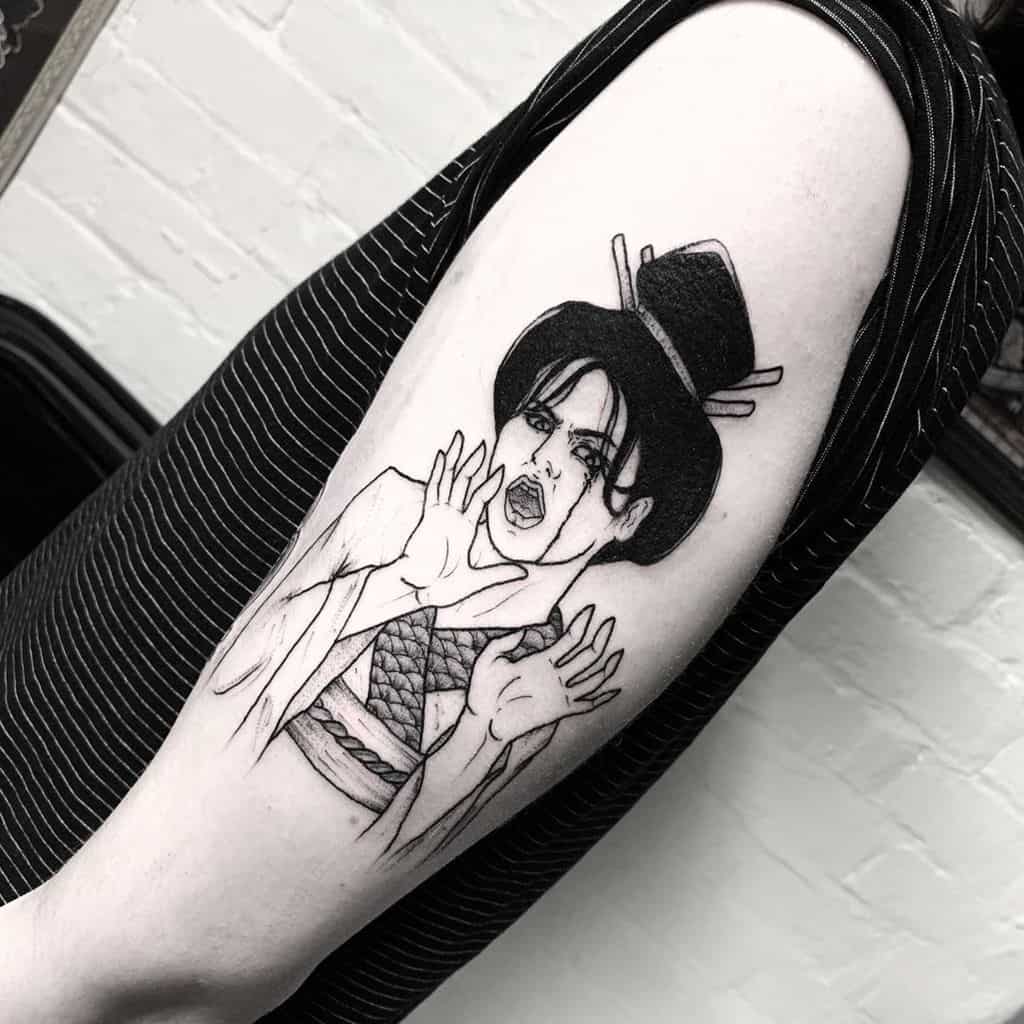 Black ink linework tattoo of a Geisha with an expressive face, hands raised dramatically, wearing traditional attire and a hairpiece.