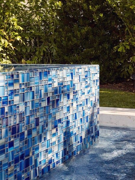 A vibrant glass tile design featuring various shades of blue, perfect for creating a striking waterline or accent wall in a pool.