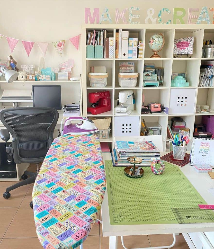 Creative sewing room with a colorful ironing board, organized shelving, and crafting supplies neatly arranged.