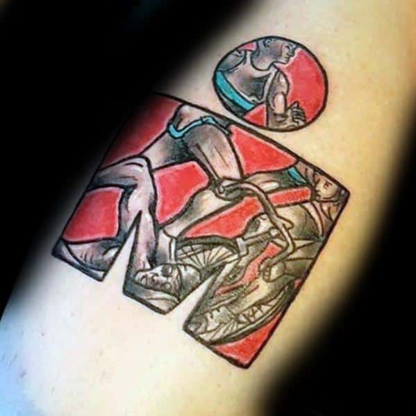 Ironman logo tattoo with illustrations of a swimmer, cyclist, and runner, set against a red background, symbolizing the three disciplines of the triathlon.
