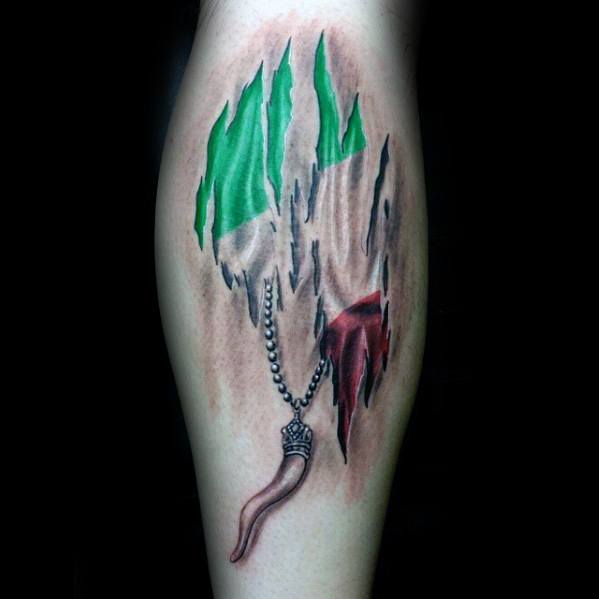 Leg tattoo with a torn skin effect revealing the Italian flag, featuring a cornicello amulet pendant, symbolizing heritage, protection, and luck.