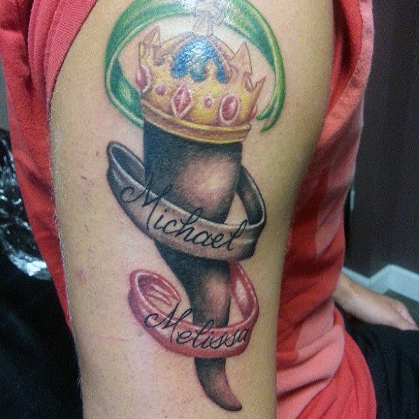 Italian horn tattoo with a golden crown and ribbon featuring 'Michael' and 'Melissa,' symbolizing love, protection, and heritage.